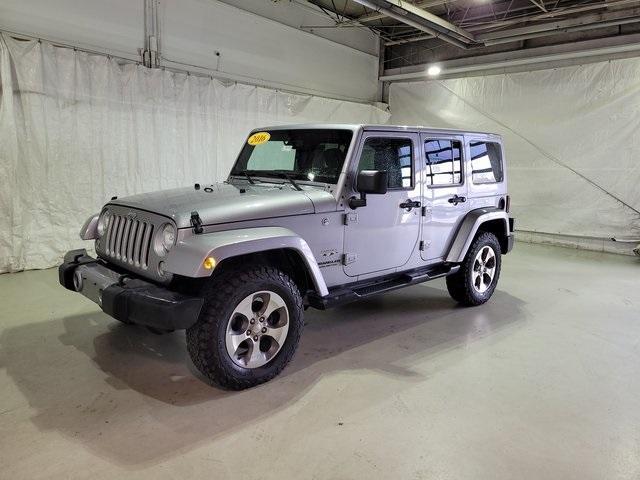 Used 2016 Jeep Wrangler Unlimited Sahara with VIN 1C4BJWEGXGL262342 for sale in Pinconning, MI